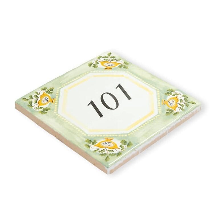 | Your house number tile designed in English style. A StoryTile always includes a hanging system, ready to hang the tile right away. If you want to use the tile as a house number, there are 2 options to ensure the tile will stick to the wall in rainy and stormy weather. You can glue the tile directly to the wall or you can purchase the hanging plate. You can find this handy accessory under Frames & Holders in the menu.